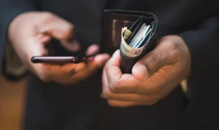 wallet with money and a cellphon 1781526100